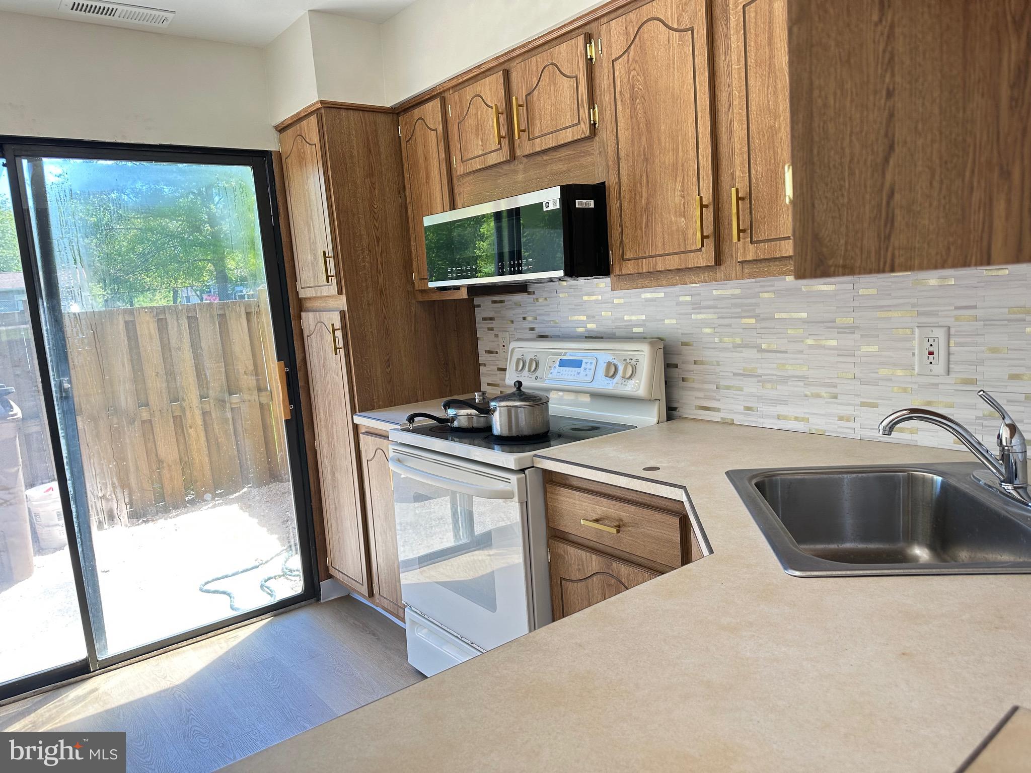 3 Centennial Road Telford, PA 18969 - Photo 5 of 25 a kitchen with stainless steel appliances a sink a stove a microwave a refrigerator and cabinets