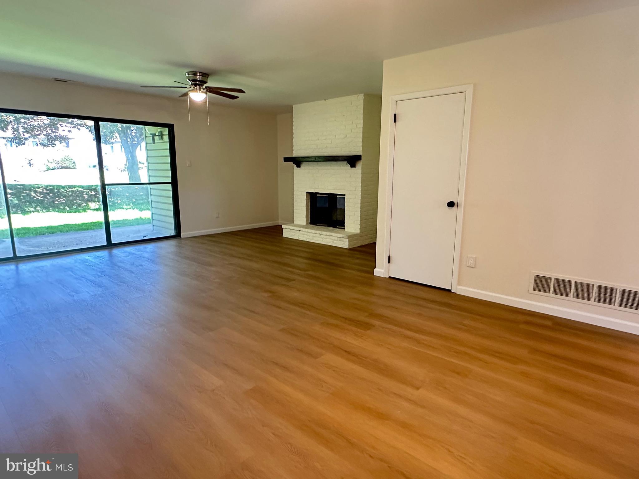 3 Centennial Road Telford, PA 18969 - Photo 9 of 25 an empty room with wooden floor fireplace and windows