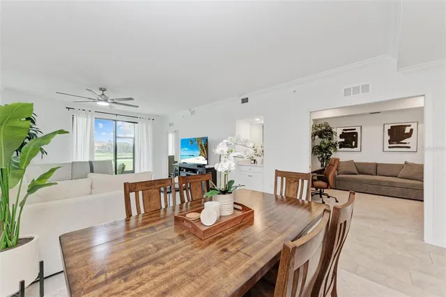 a living room with furniture a window and a flat screen tv