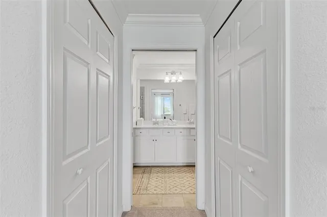 a living room with furniture a mirror and a view of kitchen