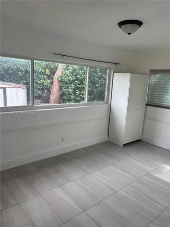 a front view of a house with a garden and yard