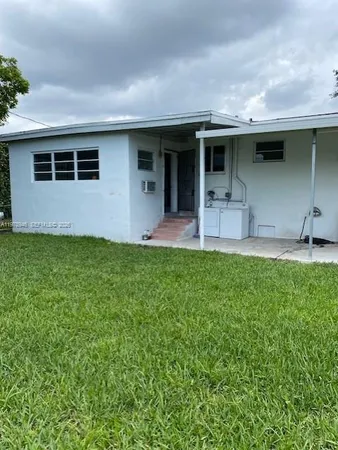 a view of a backyard with a small cabin