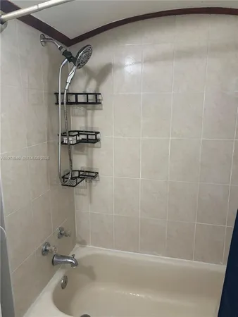a bathroom with a shower and a bath tub