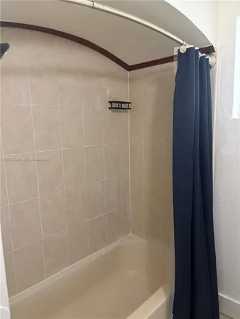 an empty room with closet and a chandelier fan