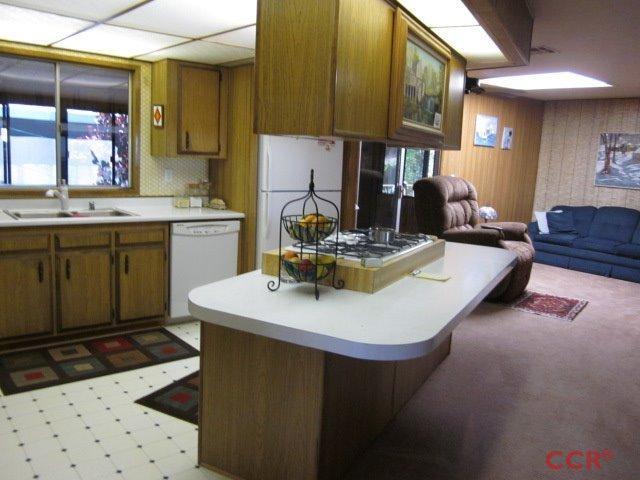 153 Val Verde Solvang, CA 93463 - Photo 4 of 13 a kitchen with a sink a stove and chairs