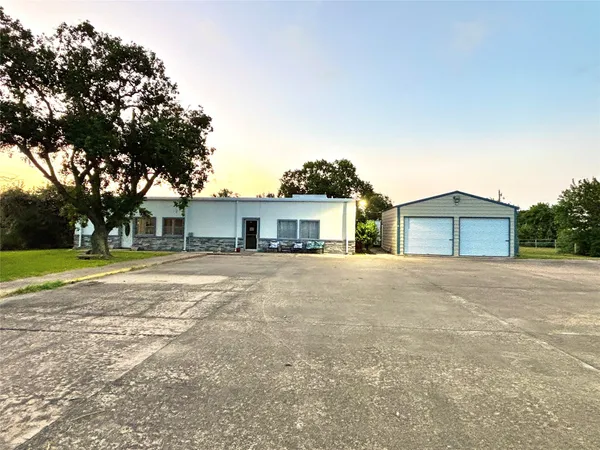 a front view of a house with a yard and trees