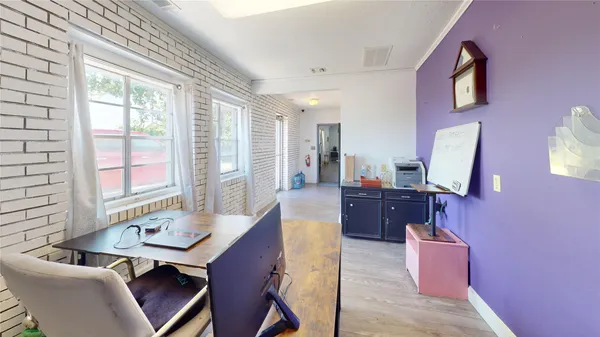 a view of a brick building with wooden fence