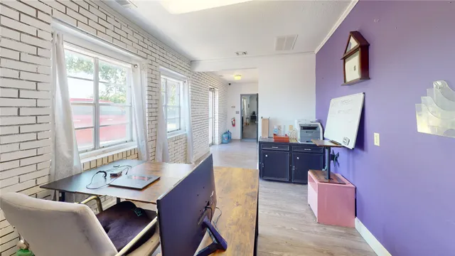 a view of a brick building with wooden fence
