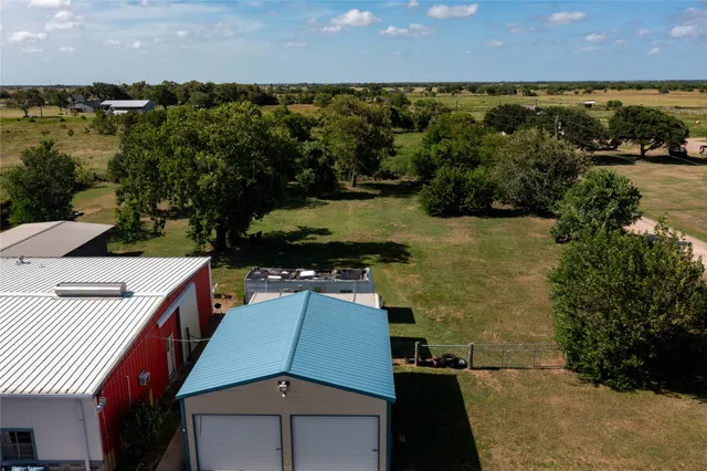 a kitchen with stainless steel appliances kitchen island granite countertop a refrigerator and cabinets