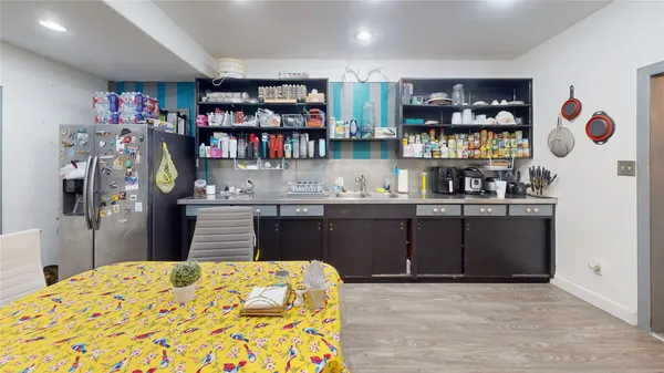 a kitchen with stainless steel appliances granite countertop a refrigerator and a stove