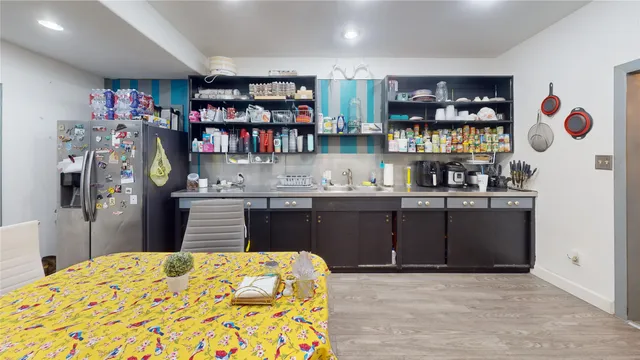 a kitchen with stainless steel appliances granite countertop a refrigerator and a stove