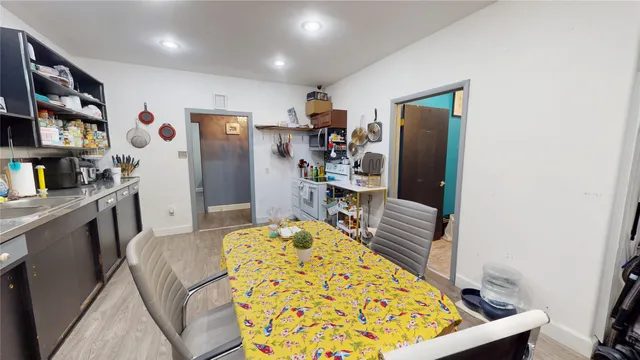 a view of a dining room with furniture and a bookshelf