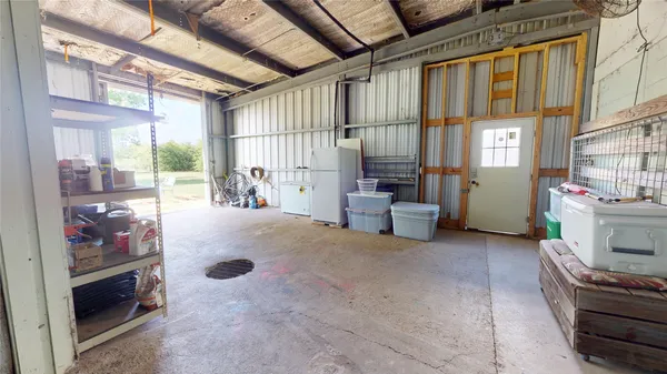a utility room with dryer washer and a view of living area