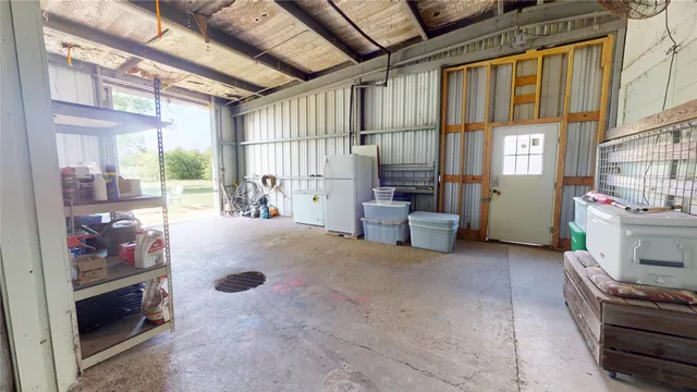 a utility room with dryer washer and a view of living area