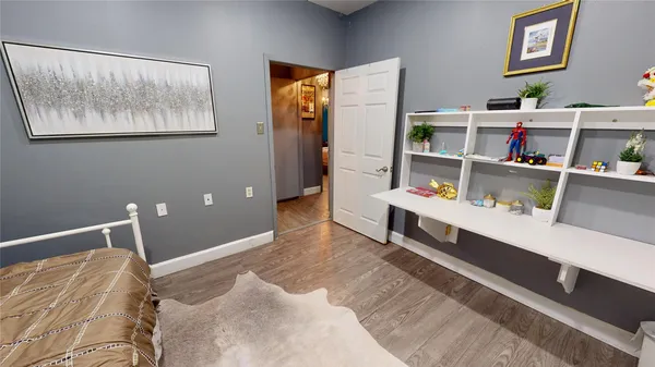 a bedroom with a bed furniture and chandelier
