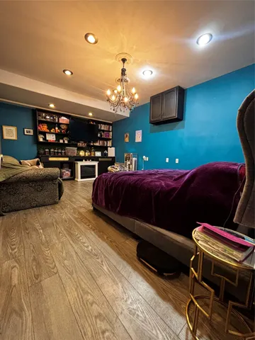 a bedroom with a bed and a painting