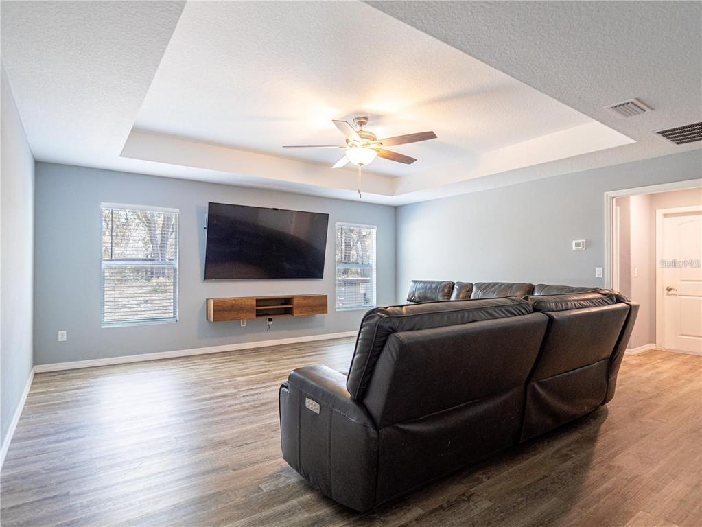 10688 Southwest 129th Terrace Road Dunnellon, FL 34432 - Photo 32 of 35 a living room with furniture and a flat screen tv