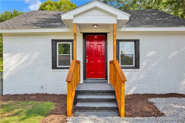 a front view of a house with wooden stairs