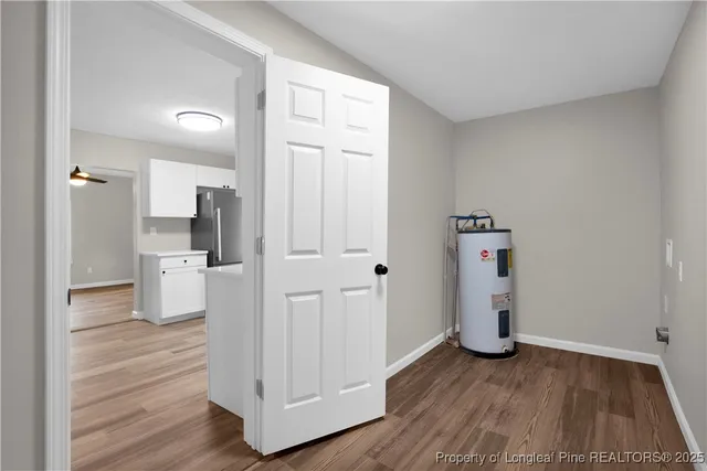 a view of a kitchen with wooden floor and electronic appliances