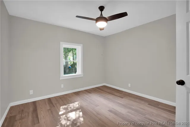 wooden floor in an empty room with a window