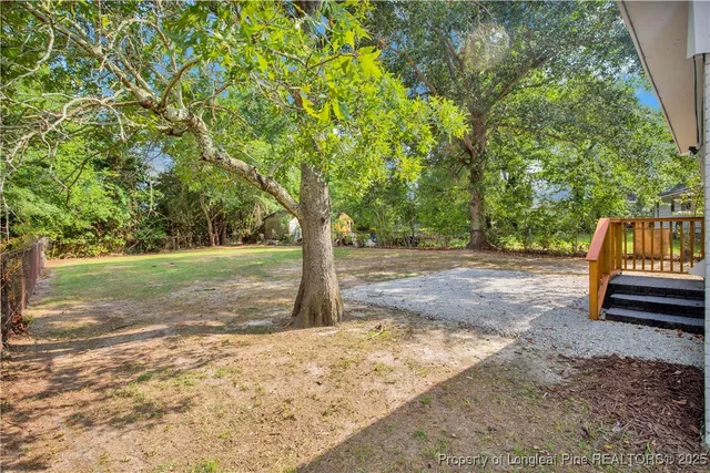 a view of a yard with tree s