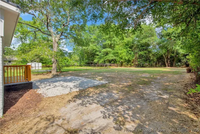 a view of a yard with large trees