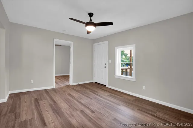 wooden floor in an empty room with a window