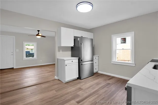a kitchen with stainless steel appliances a refrigerator microwave and sink