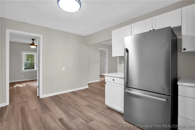 a metallic refrigerator freezer sitting in a kitchen