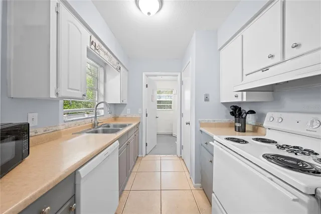 a kitchen with stainless steel appliances a stove a sink and cabinets