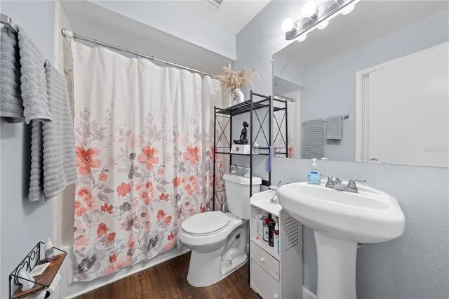 a bathroom with a sink toilet and shower