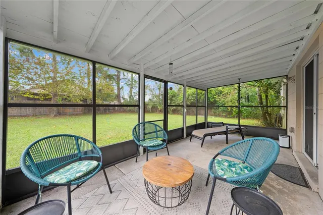 a living room with furniture and a floor to ceiling window