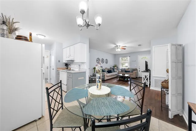 a view of a dining room with furniture and a chandelier