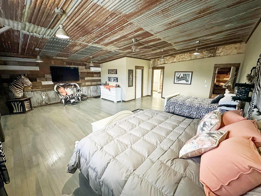 1990 Jim Harry Loop Sunset, TX 76270 - Photo 18 of 39 a bed room with furniture and a flat screen tv