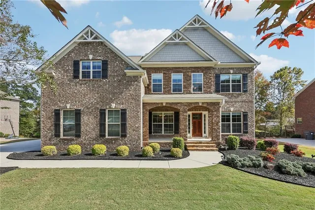 a front view of a house with a yard