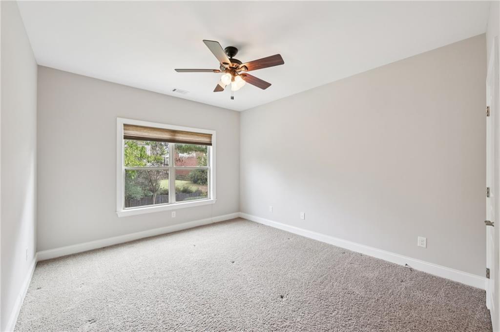 3328 Knight Road Marietta, GA 30066 - Photo 11 of 44 an empty room with windows and fan