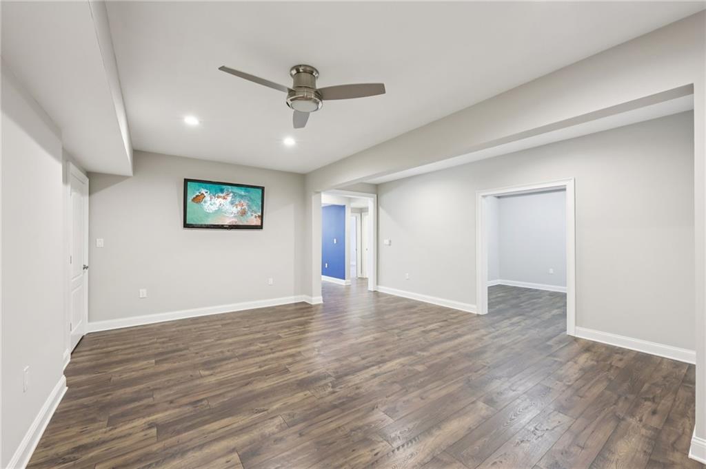 3328 Knight Road Marietta, GA 30066 - Photo 24 of 44 a view of an empty room with wooden floor and a ceiling fan