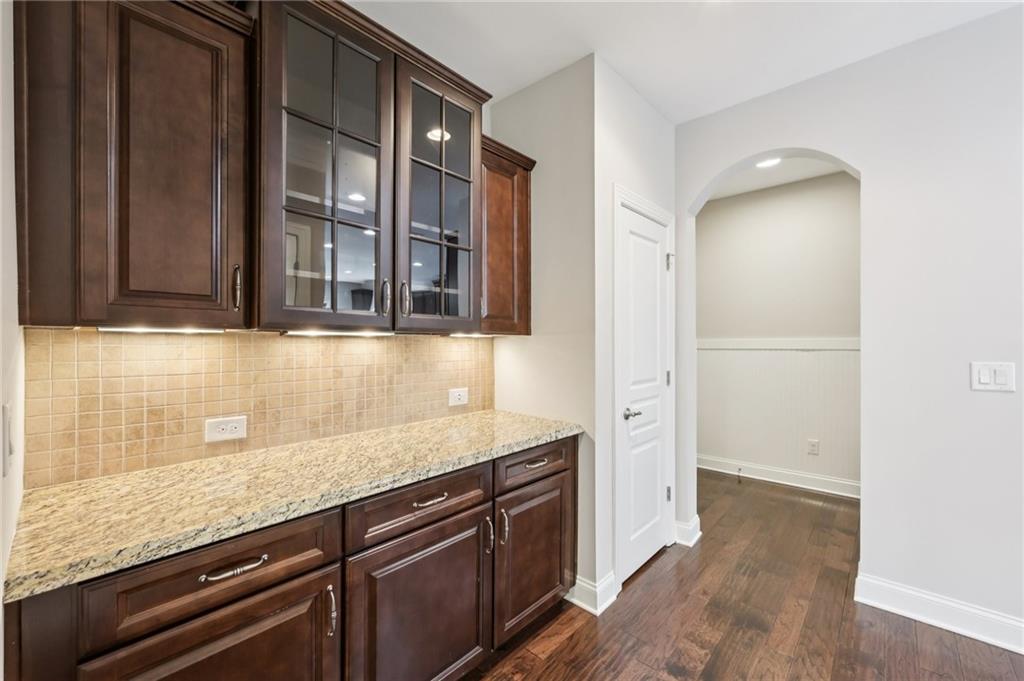 3328 Knight Road Marietta, GA 30066 - Photo 10 of 44 an empty room with granite countertop cabinets and wooden floor
