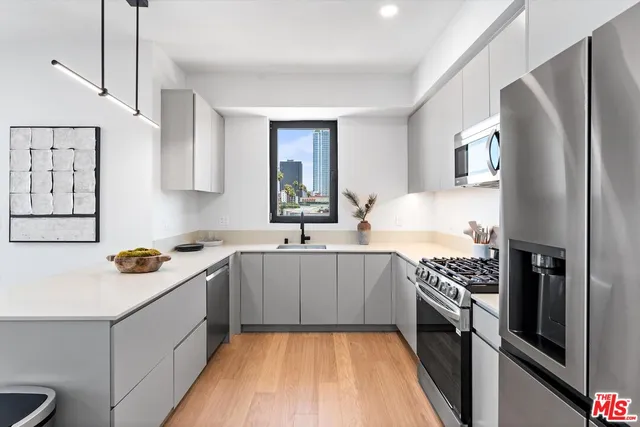 a kitchen with stainless steel appliances a sink stove and refrigerator