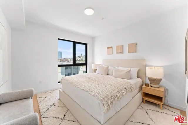 a bedroom with a large bed and a window