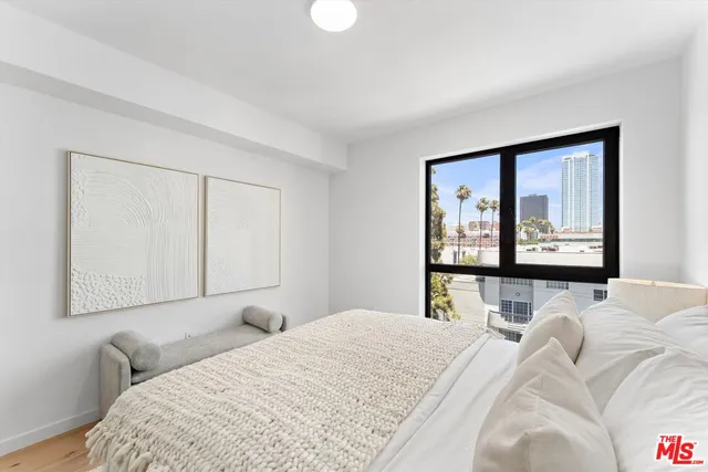 a bedroom with a large bed and a window