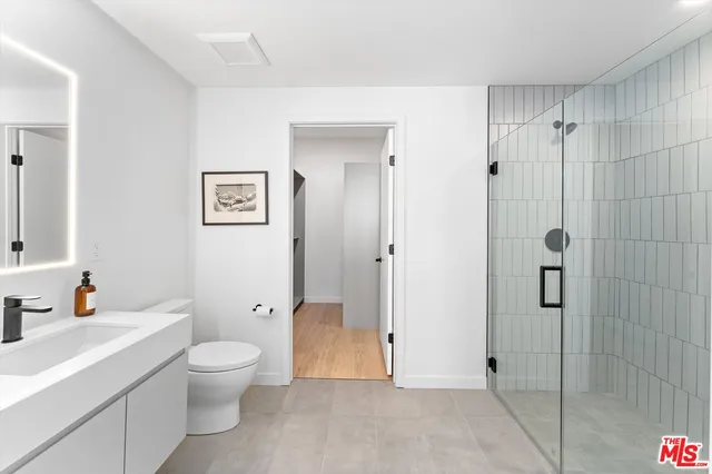 a bathroom with a toilet sink and shower