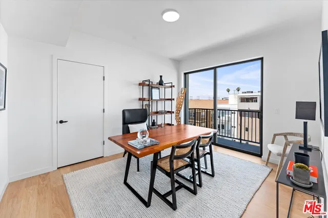 a view of a livingroom with furniture and a book shelf