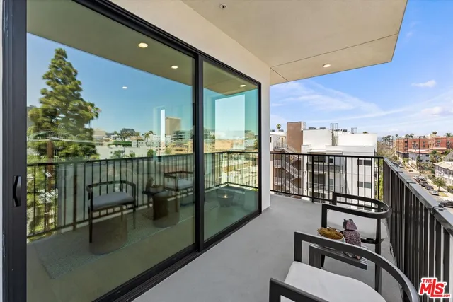 a view of a balcony with chairs