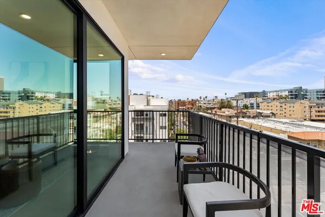 a view of a balcony with wooden floor and city view