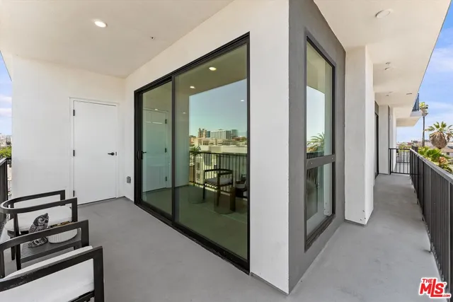 a view of a balcony with chairs