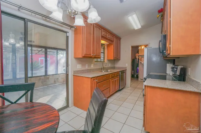 a kitchen with stainless steel appliances granite countertop a sink and a microwave