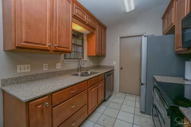 a kitchen with granite countertop a stove and a microwave