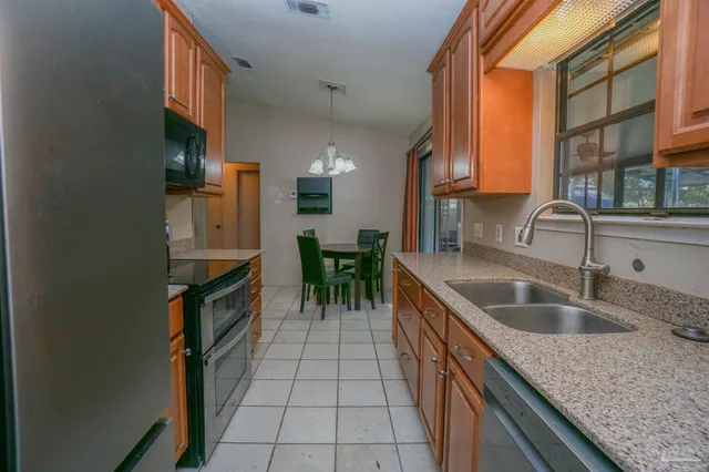 a kitchen with stainless steel appliances granite countertop a stove a microwave and a refrigerator