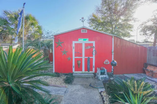 a front view of a house with garden and sitting area